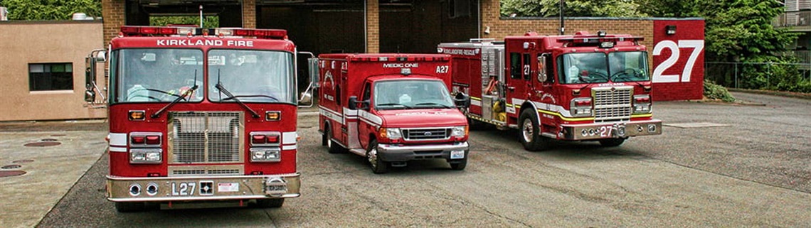 Three fire department vehicles in front of Fire Station