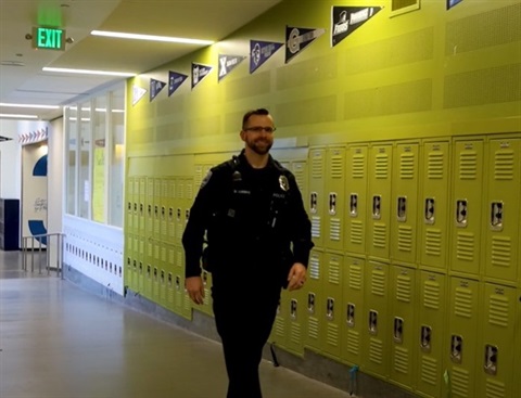 School Resource Officer walking in school hallway