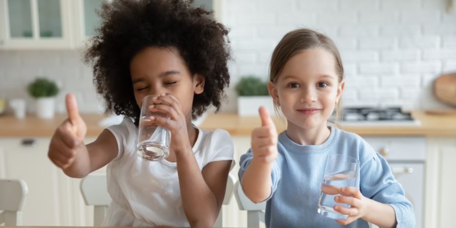 Drinking Water Quality banner - image with two children drinking water with thumbs up