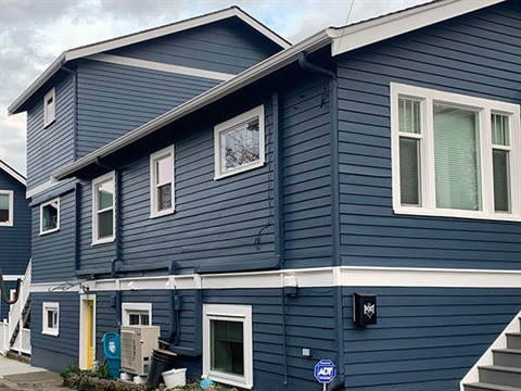 heat pump on the side of a blue house