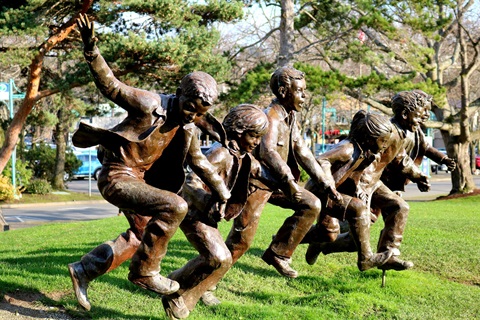 Life size bronze statute of children running